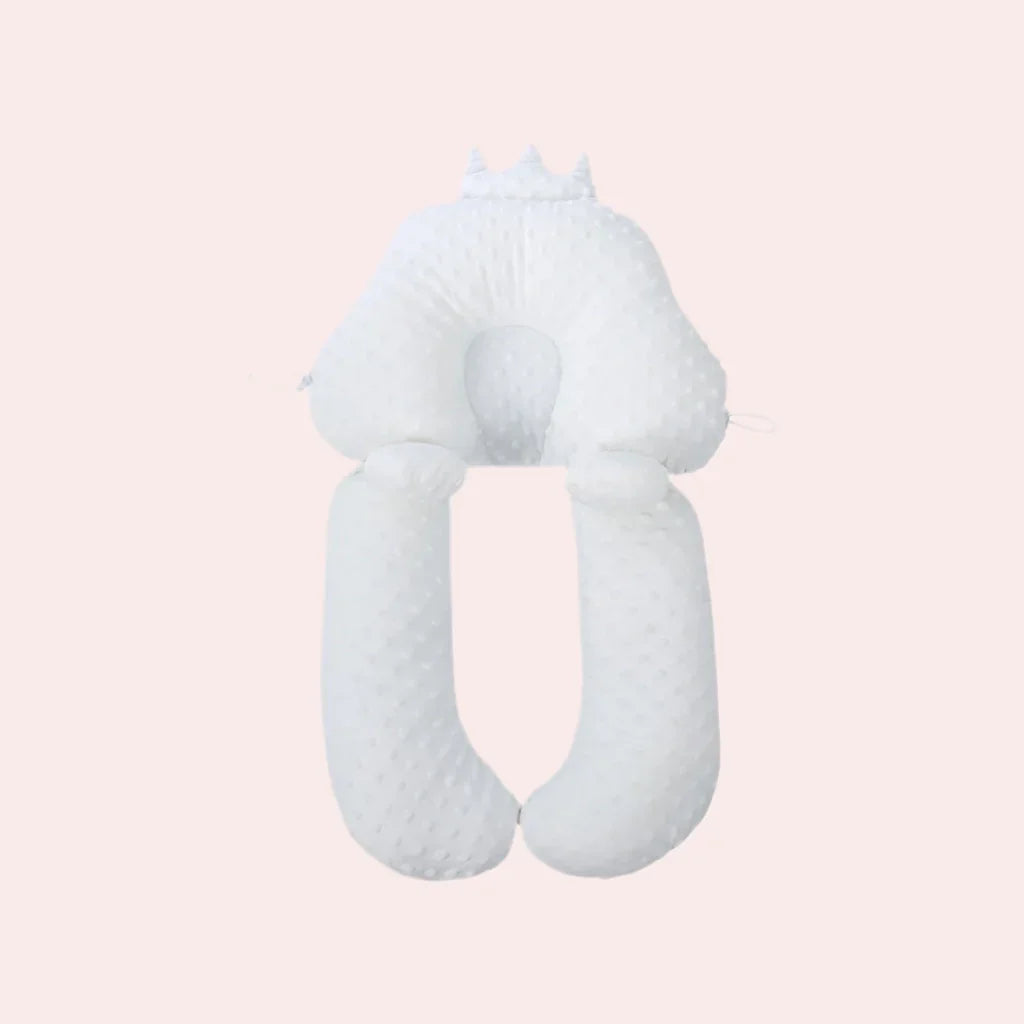 White crown-shaped baby support pillow with round center pad and two long side rolls