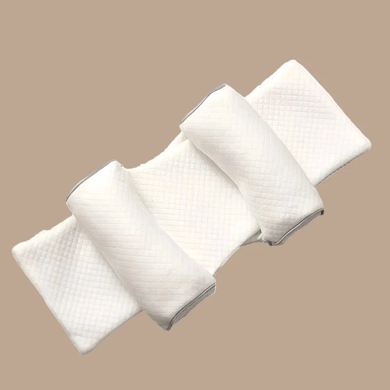 White multi-roll baby support pillow with rectangular base and four padded rolls
