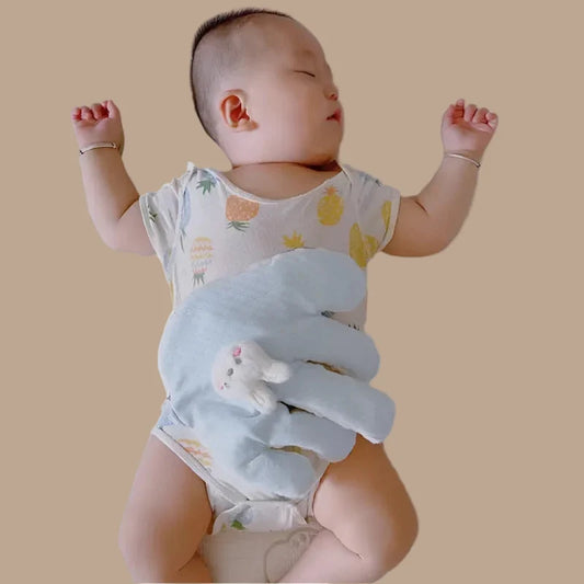 Blue hand-shaped sleeping palm plush placed across an infant in the current Shopify featured image