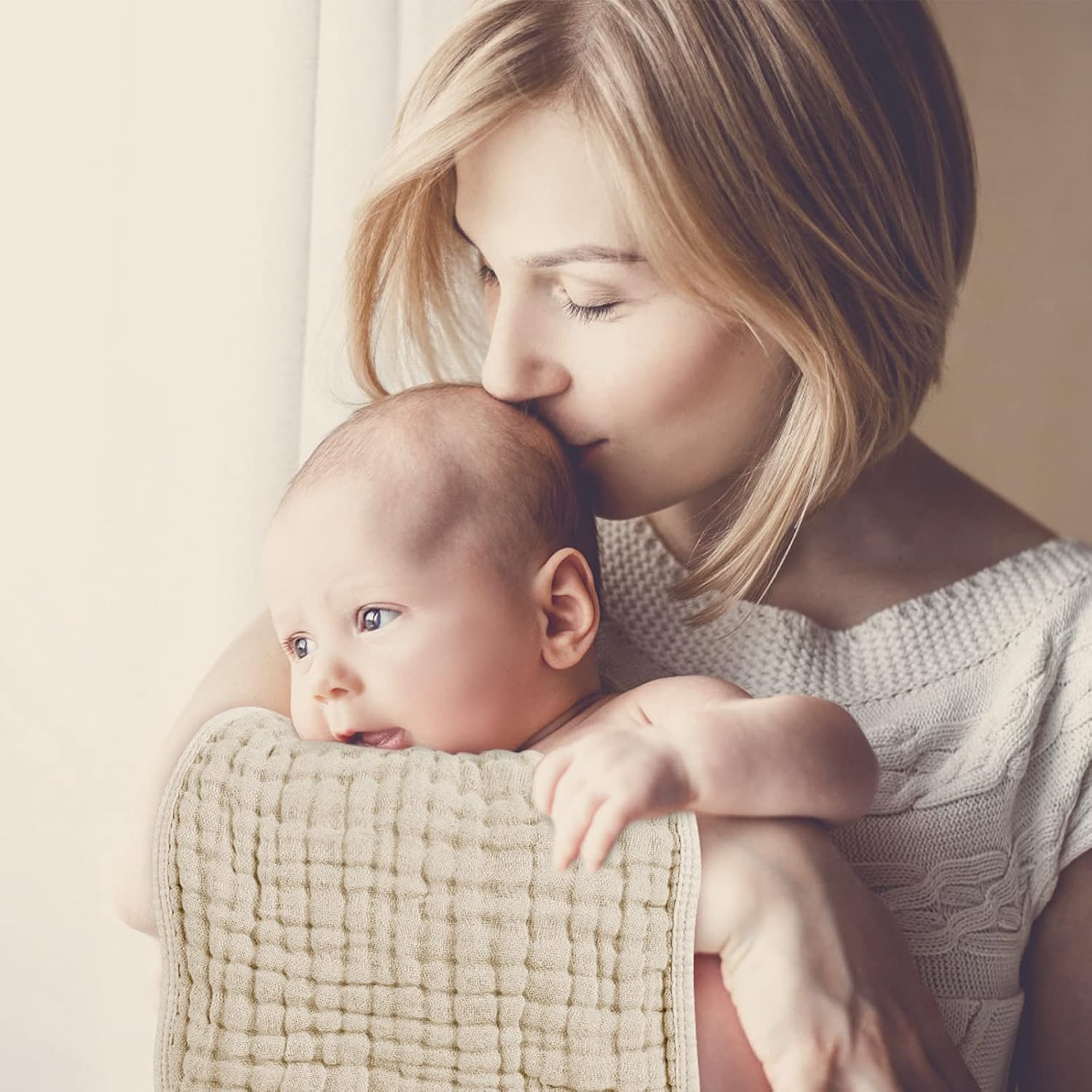 Mother cradles baby with soft 100% cotton muslin burping cloths (six-pack), skin-friendly and pre-washed.