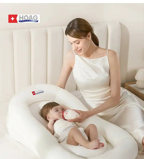 Adjustable baby lounger with mother feeding infant