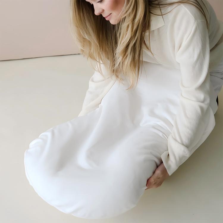 Mother holding a baby lounger cushion with removable white cover