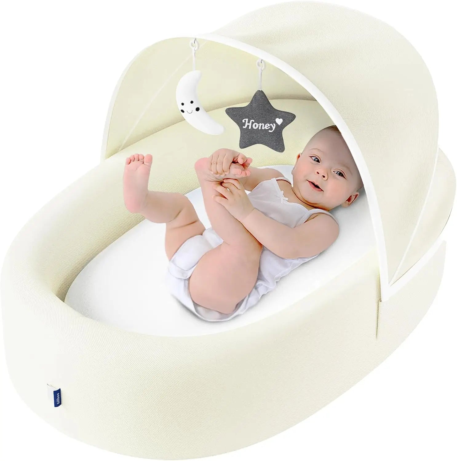 Cream color baby nest lounger with star mobile