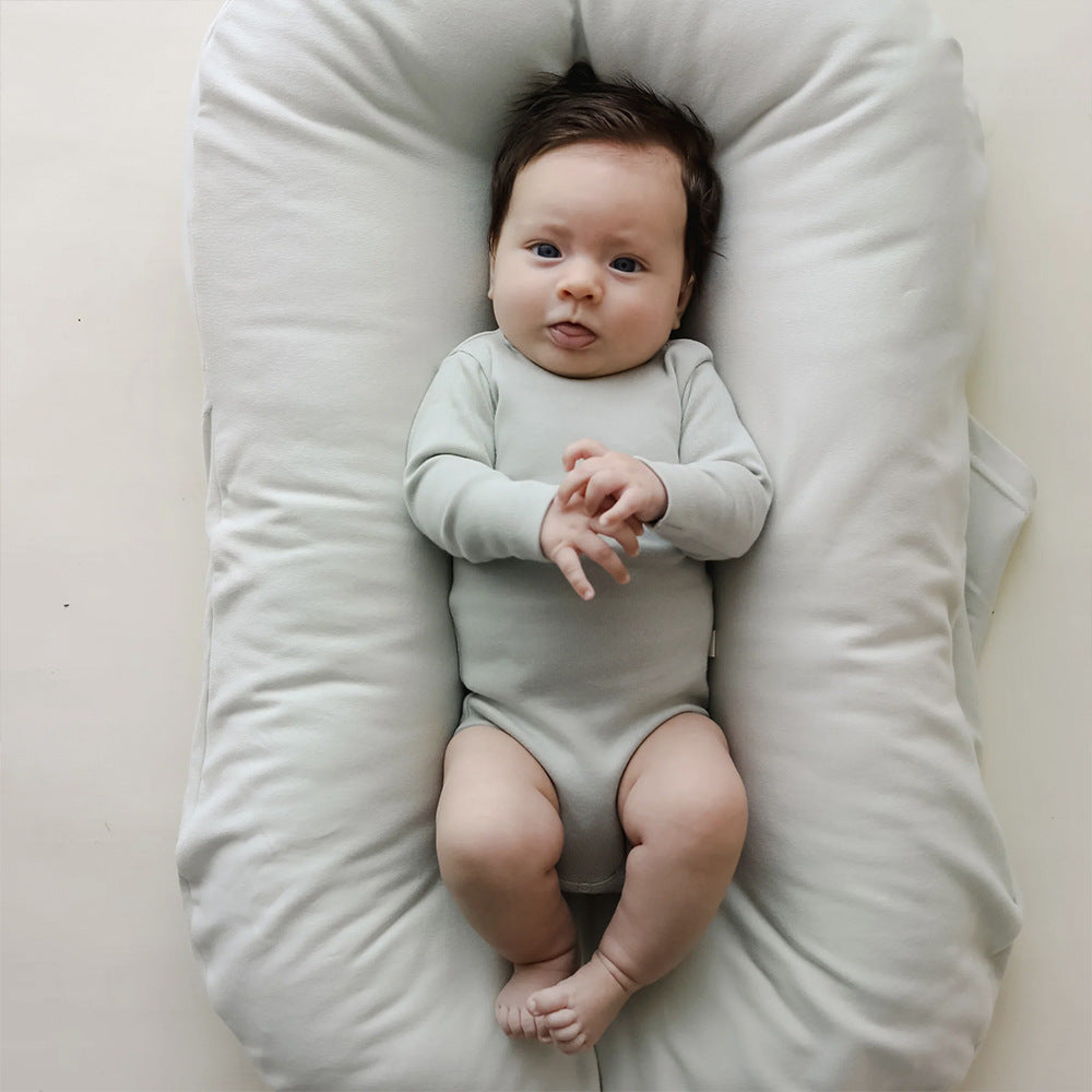 Infant resting comfortably on a soft baby lounger cushion
