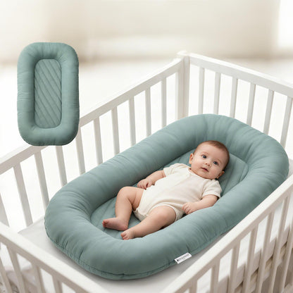 Striped infant lounger bed fitted inside baby crib