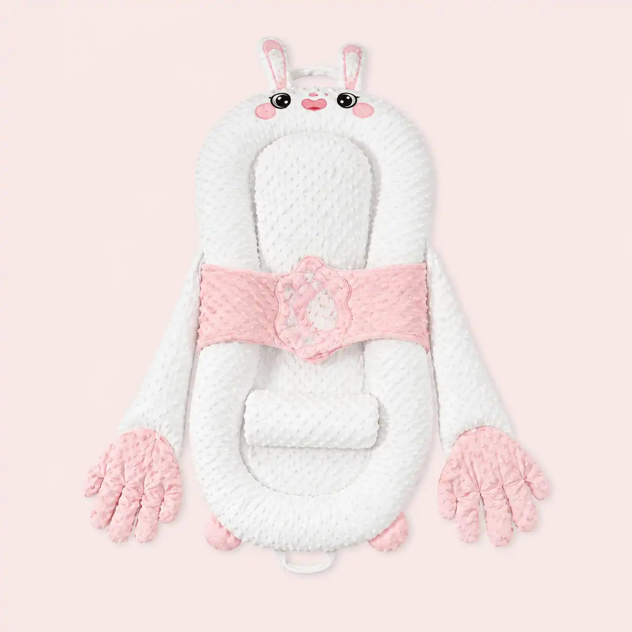 Pink bunny smart patting baby lounger with plush hands on a pale pink background