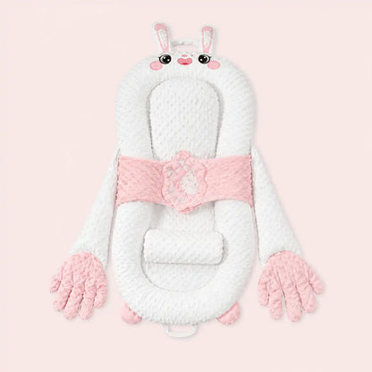 Pink bunny smart patting baby lounger with plush hands on a pale pink background