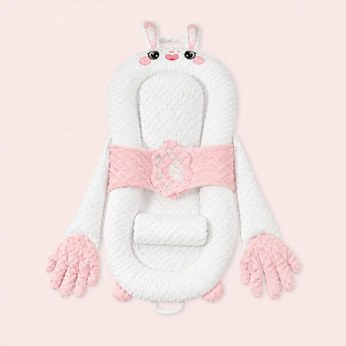 Pink bunny smart patting baby lounger with plush hands on a pale pink background